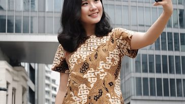 Seorang remaja mengenakan batik sedang selfie untuk feed instagram-nya.