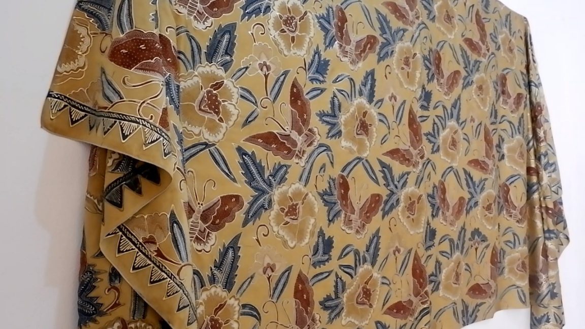 Karya batik prada Mawar Kupu-Kupu Syamsul Huda menampilkan harmoni alam dan perjalanan manusia melalui revitalisasi teknik batik klasik.